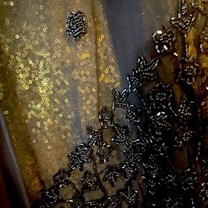 Black sheer beaded wrap with fringe.